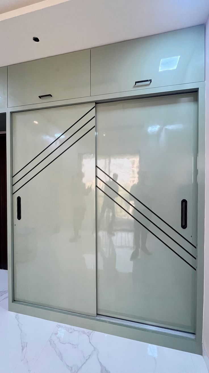 Glossy dark modular kitchen by KGN Interior Factory